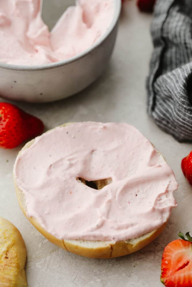 Strawberry cream cheese on a bagel. 