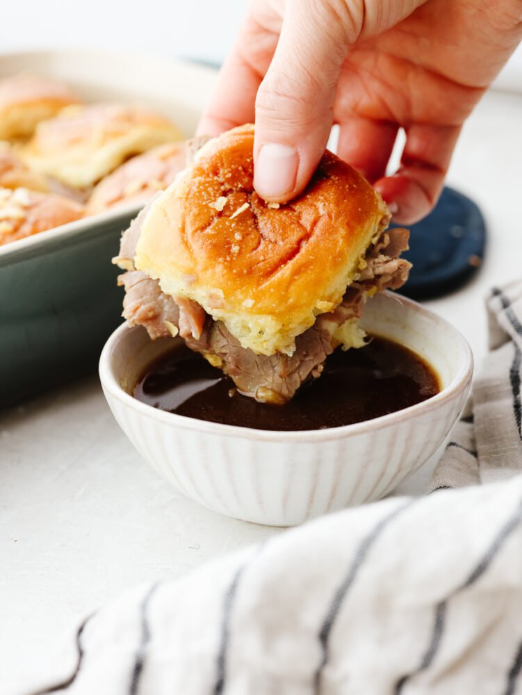 Dipping a slider into au jus sauce.