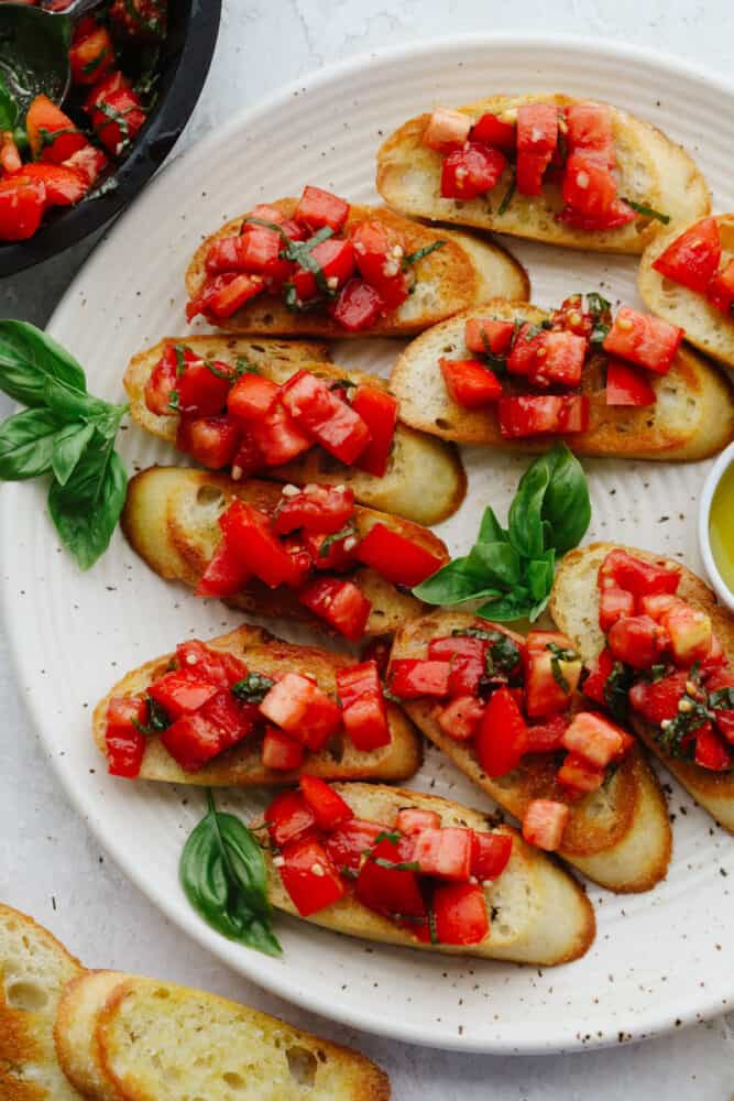 Crostini pieces topped with tomato basil salad.