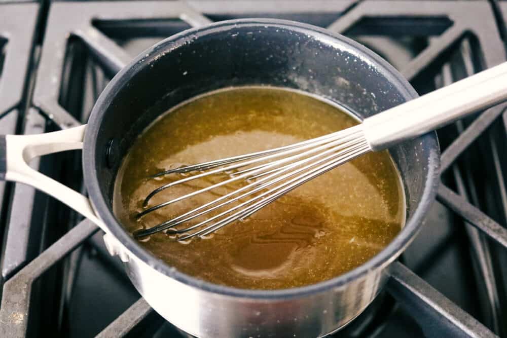 The honey butter syrup in a pan on the stove. 