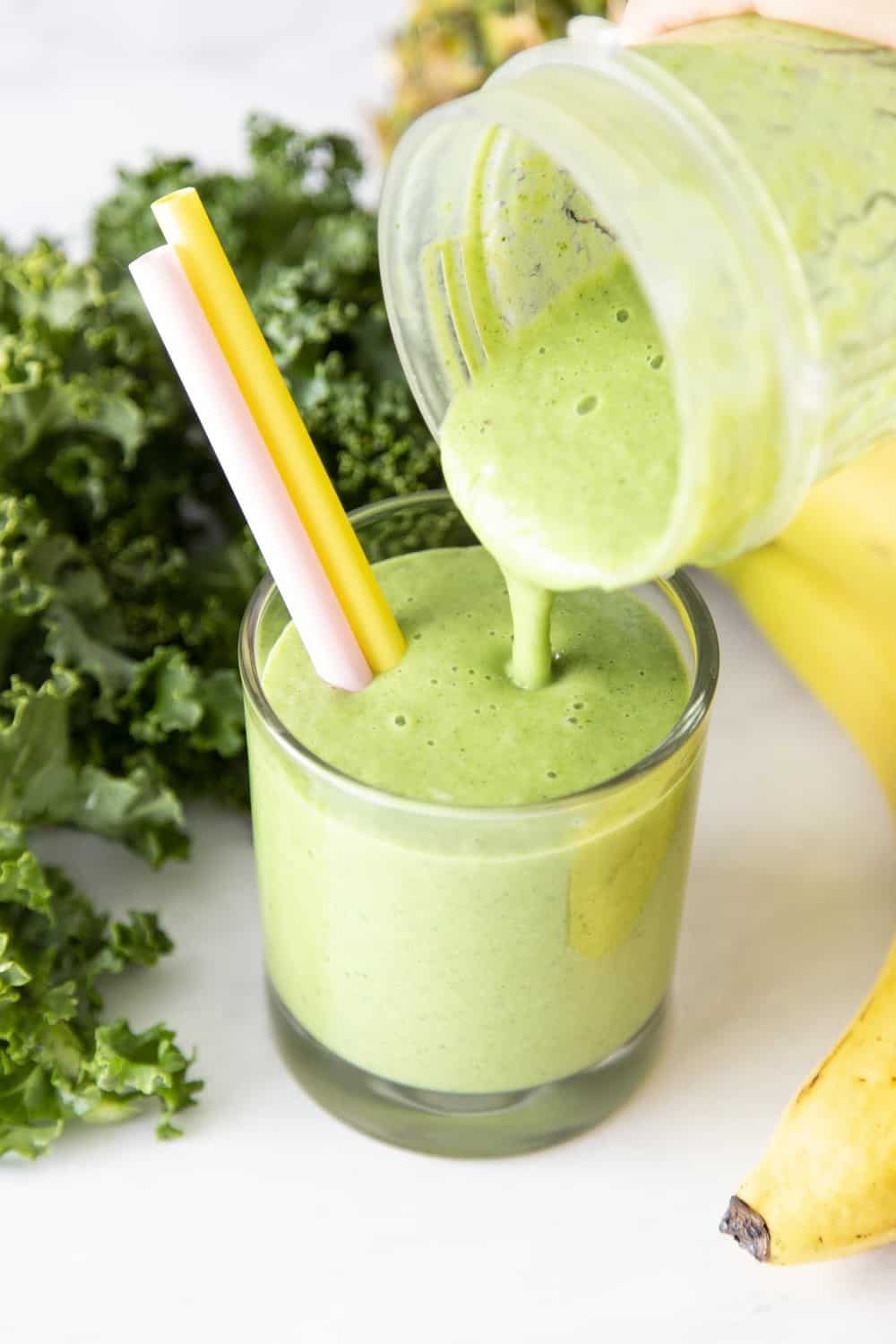 Kale smoothie being poured into a glass