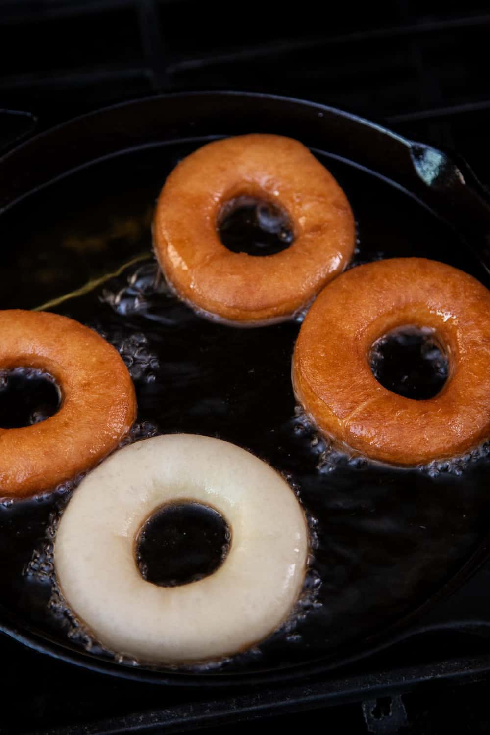 Frying donuts in a cast iron pan
