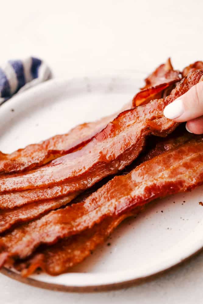Perfectly Baked Crispy Bacon on a white plate.