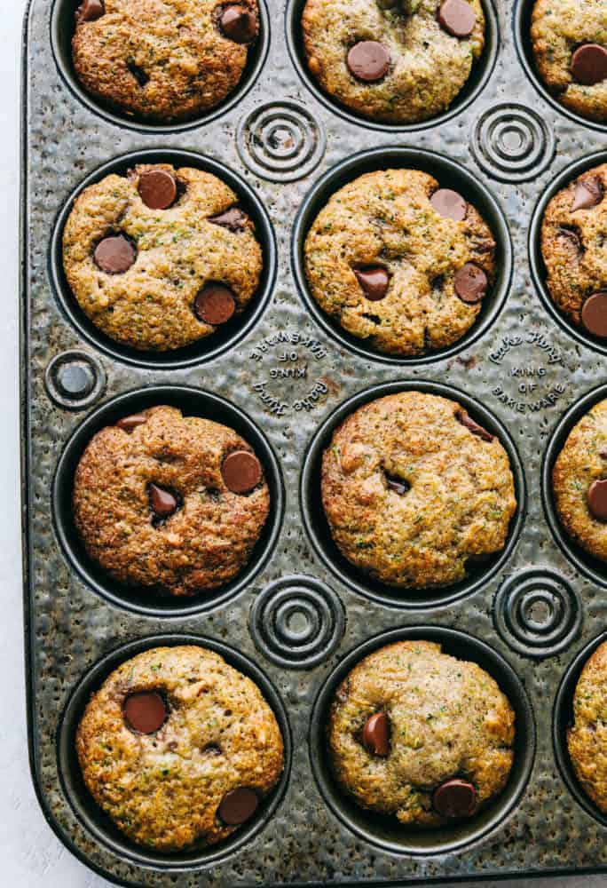 Chocolate chip zucchini muffins in a baking pan.