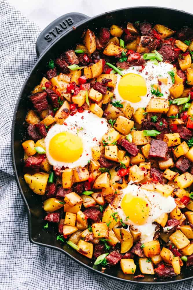 Corned beef in a skillet with eggs on top.