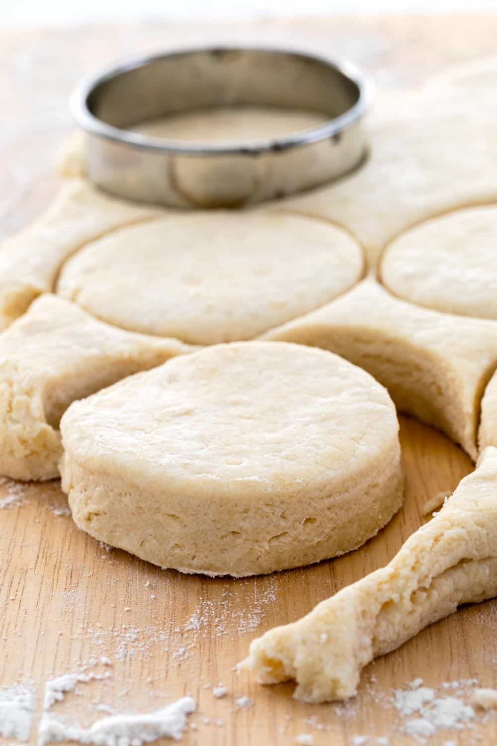 stamping out rounds of biscuits from dough
