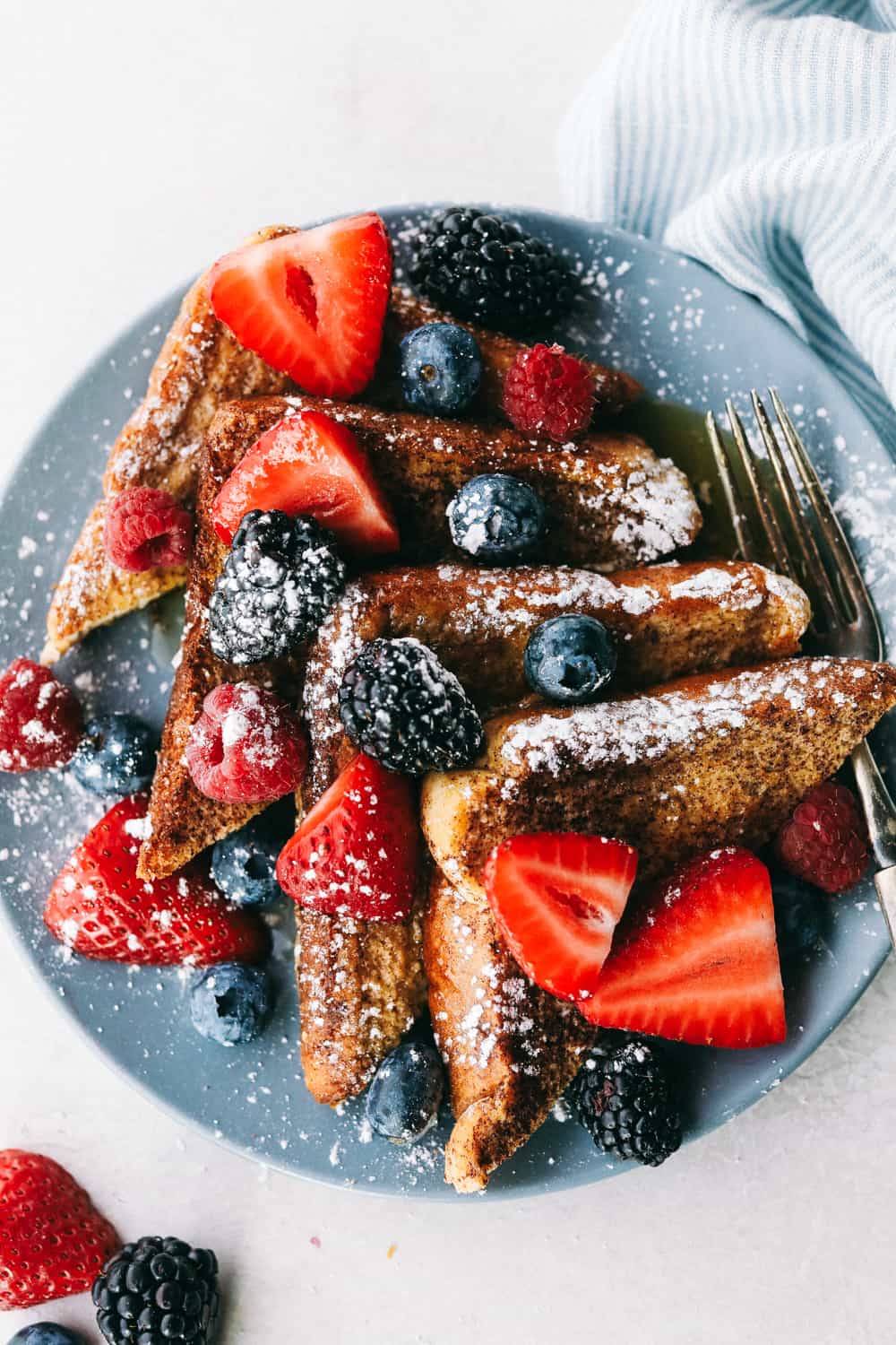 sliced French toast with berries on a plate