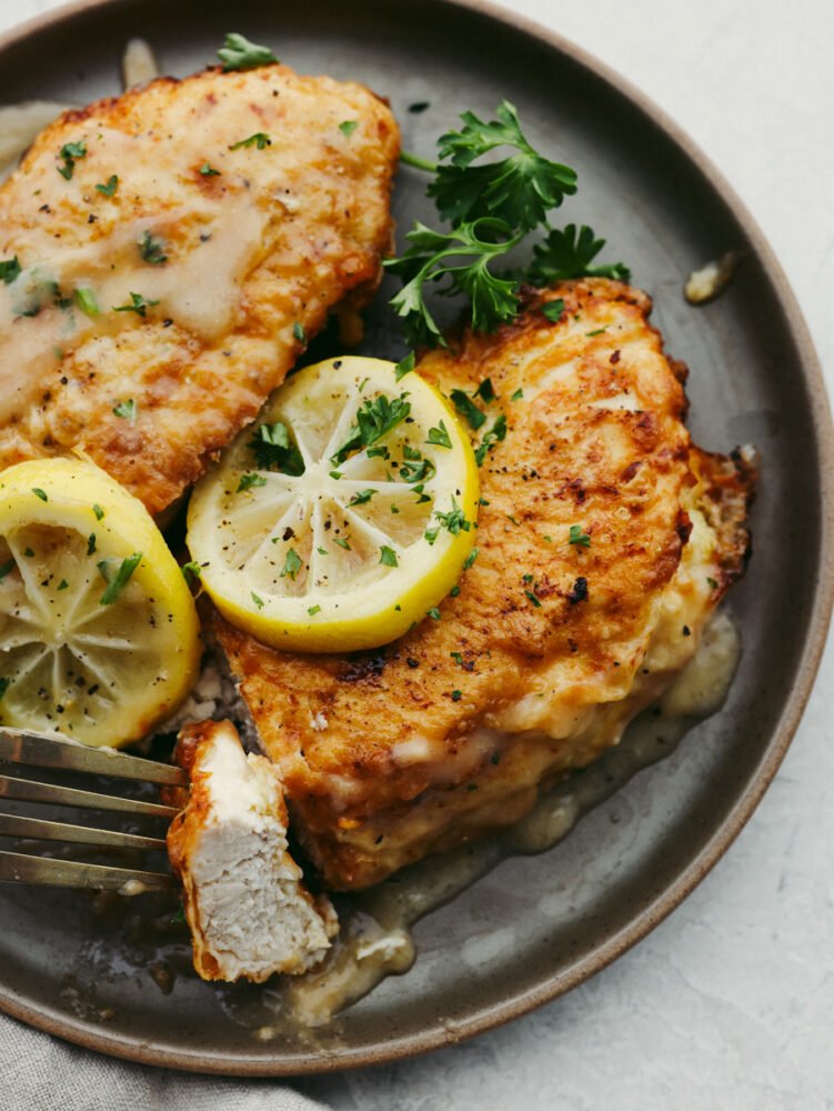 Chicken Francese on a plate that is garnished and ready to eat. 