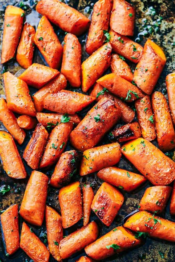 Roasted carrots spread out on a trayl