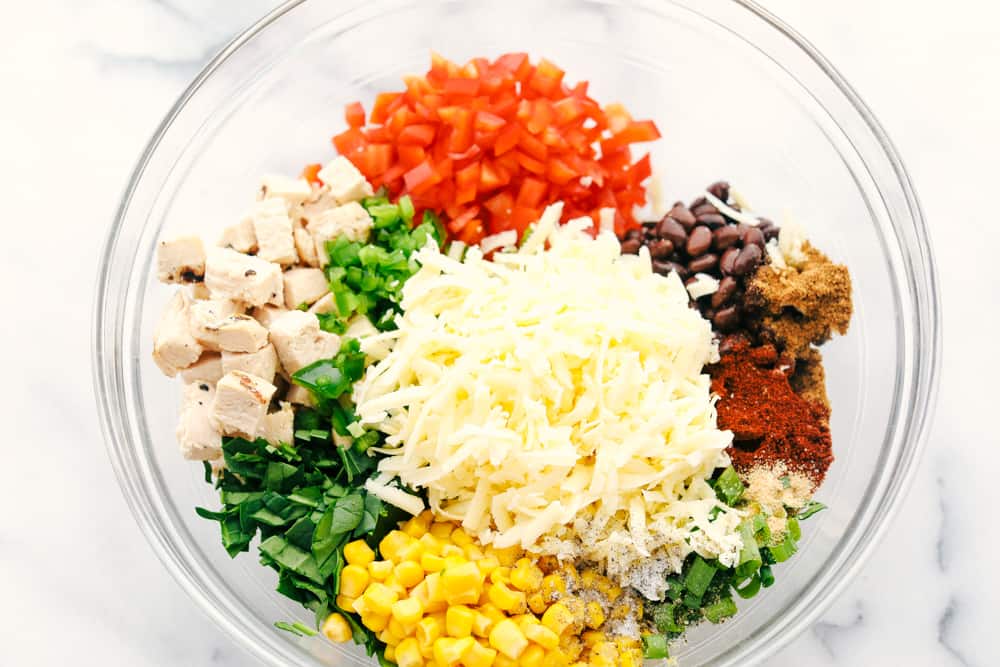 Chicken, bell pepper, black beans, cheese, seasoning and corn all in one bowl. 