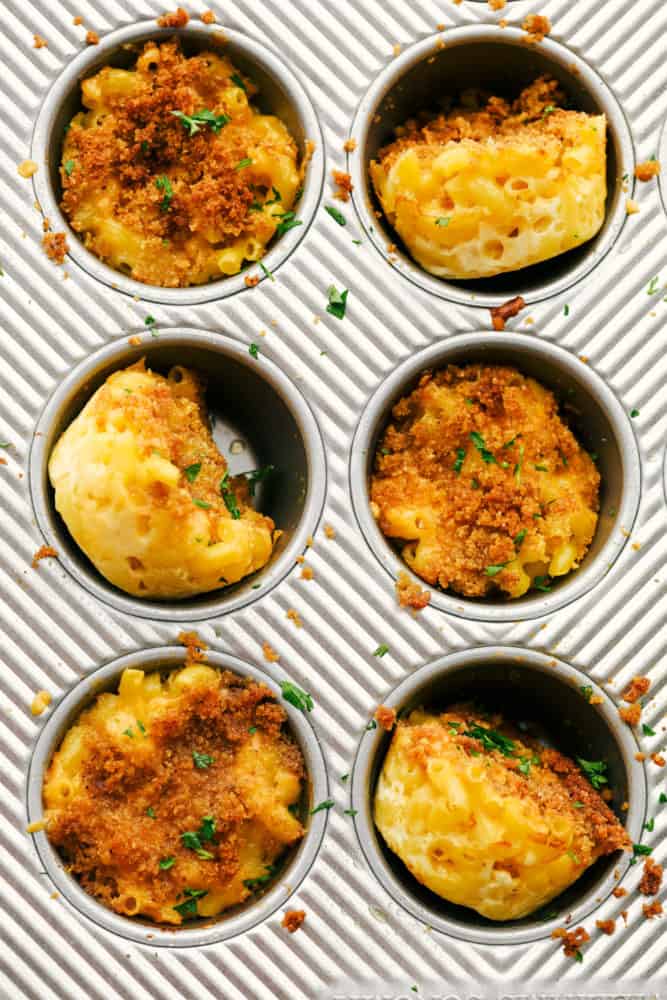 Finished mac and cheese cups in a muffin tray.