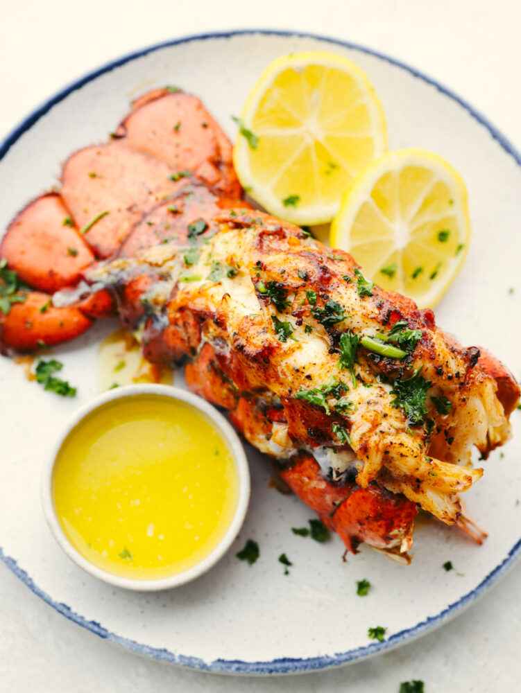 Lobster on a plate with lemon slices and butter. 