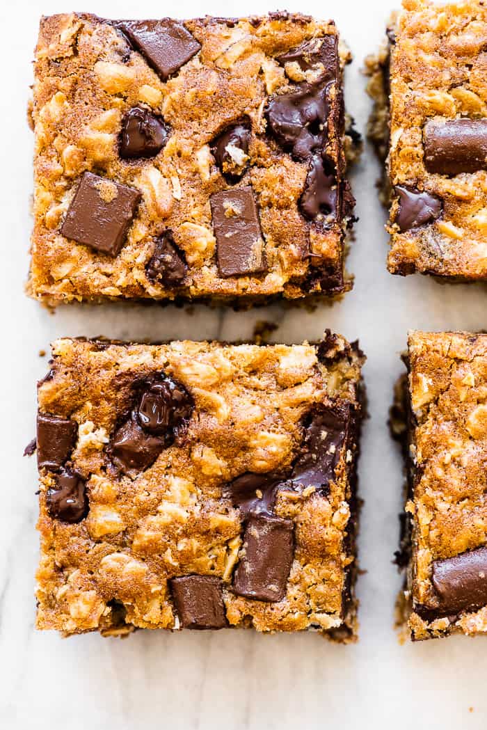 Oatmeal chocolate chip bars on a marble countertop. 