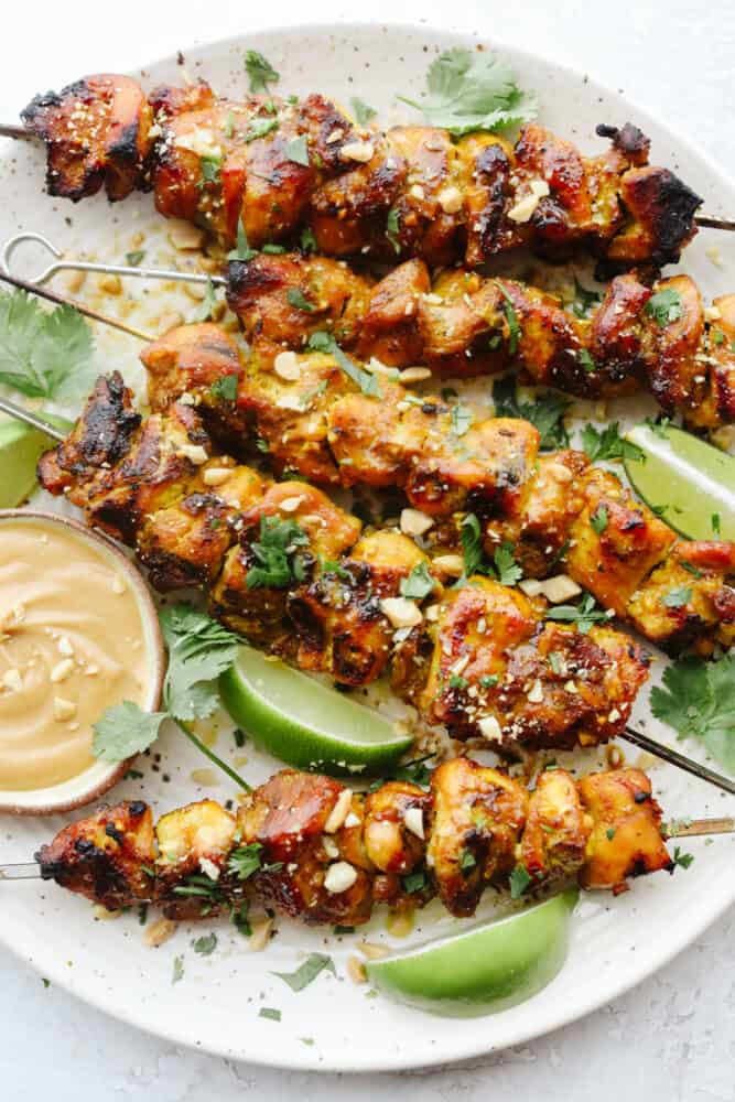 Grilled Chicken satay with peanut sauce on a plate. 