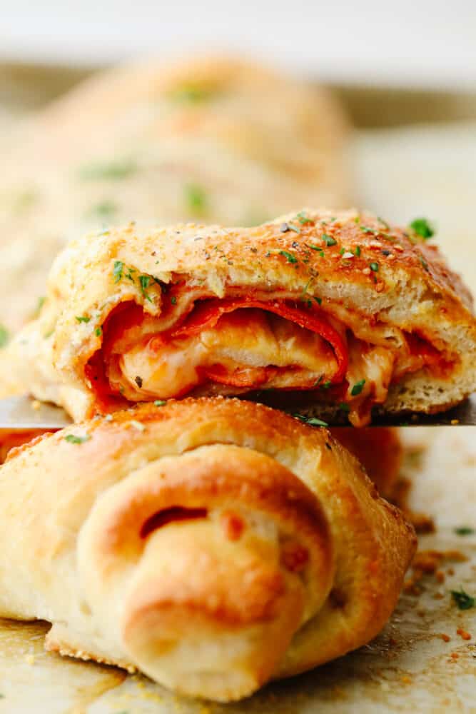 A pepperoni roll sliced and being served. 