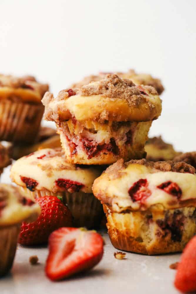 Strawberry streusel muffins stacked on top of each other. 