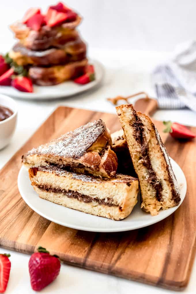 An image of nutella stuffed french toast sliced in half on a plate.