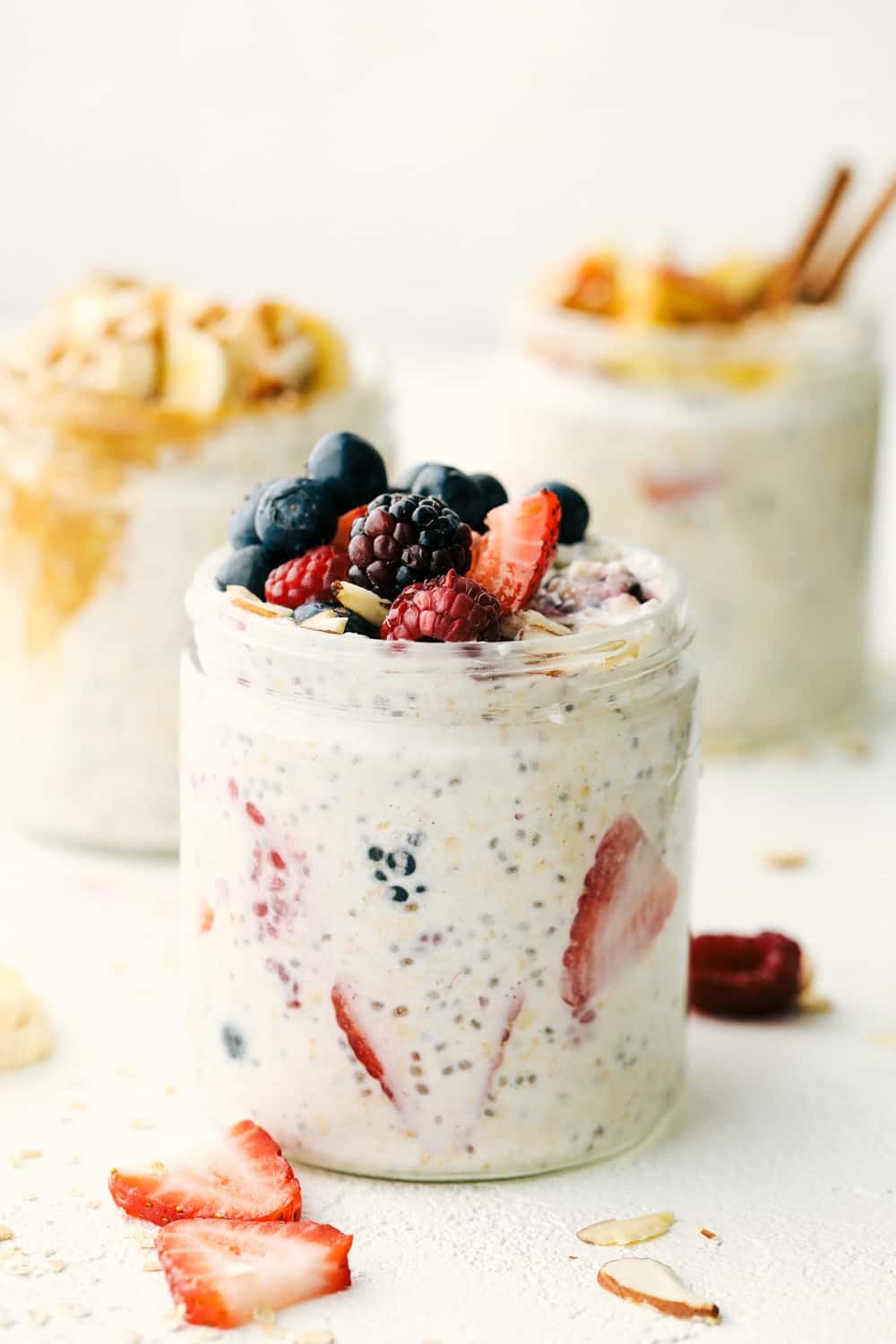 Over night oats in a jar with mixed berries on top.