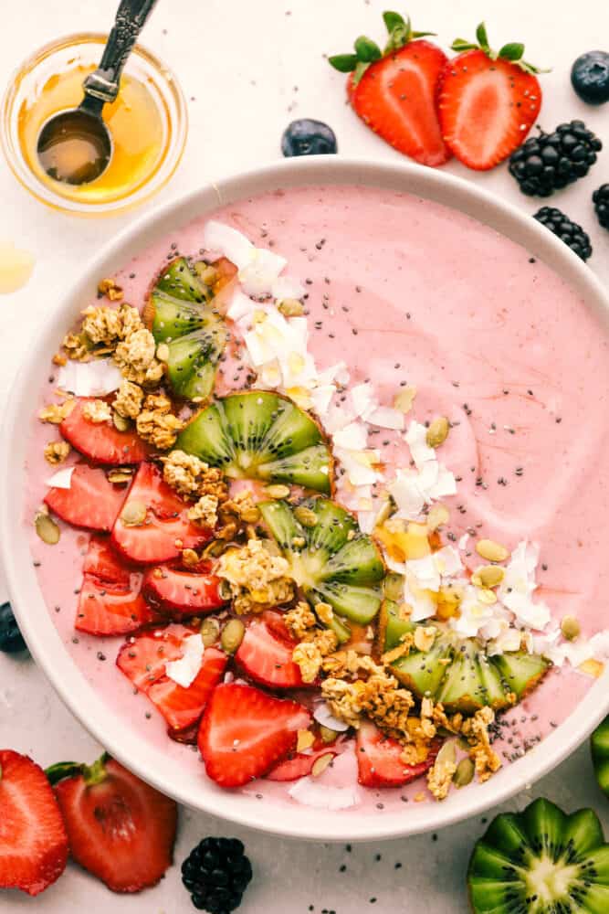 Berry Smoothie bowl topped with fruit, coconut and seeds. 